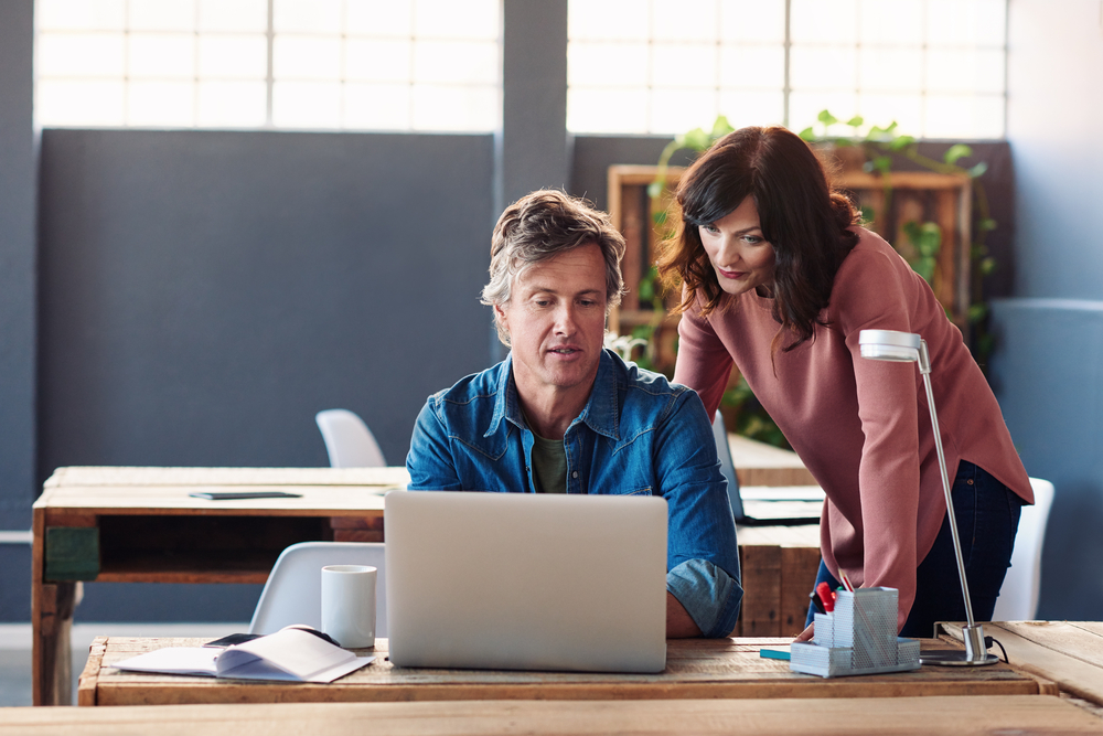 two colleagues reviewing lead generating ideas for clients